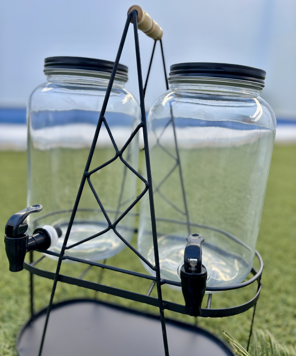 Dispensador de bebidas doble de cristal con soporte negro, diseño elegante y funcional para servir bebidas en eventos y hogar